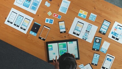 Wall Mural - top view of skilled developer walking and placing ux ui software. smart business man put tablet on m