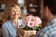 © LimeSky - Celebration of family joyful son gifts flowers to his elderly mother at home for her birthday and Mother s Day
