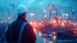 © Martinesku - A worker in safety gear observes a vibrant construction site at evening's glow, showing lit cranes and industrial activity.