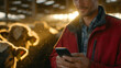 © Maksym - Vibrant farm worker in red jacket engages with mobile phone amidst gentle cows in airy barn. Sun rays highlight dust particles in golden light, symbolizing harmonious mix of techno
