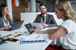 © Migma_Agency - Business people working together on project using digital tablet and laptops in office meeting room