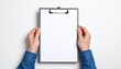 © photostockatinat - Hands holding a clipboard with a blank sheet of paper. The clipboard is grey and the hands are wearing a denim shirt.