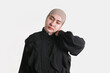 © aryamhrdk16 - Portrait of a woman in hijab touching her neck with a pained expression on isolated white background. Concept of neck pain, fatigue, stress, or muscle tension.