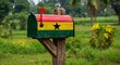 © Firman Dasmir - Ghanaian pride: A mailbox displaying the national flag in a serene landscape