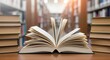 © ahmed - An open book lies on a wooden surface with stacks of books and library shelves blurred in the background, bathed in sunlight.