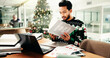 © peopleimages.com - Statistics, research and man in office with book on business guide to the galaxy for information. Laptop, Christmas and male financial manager with documents for investment graphs, data or charts.