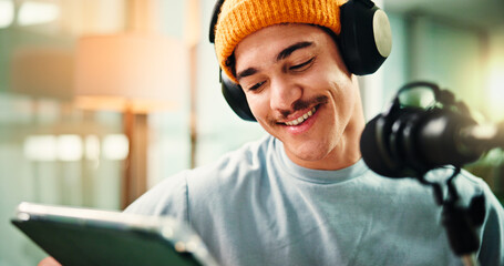Content creation, influencer and man with mic, tablet or reading script for episode, talking or app. Live streaming, podcaster and person with tech for entertainment, online and host with headphones