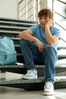 © New Africa - Teen problems. Upset teenage boy on stairs indoors