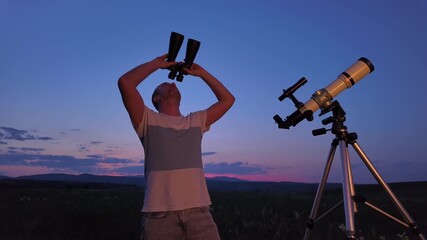 Wall Mural - amateur astronomer using telescope and binoculars for watching stars, moon, planets and other celest