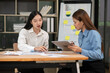 © Thitisak - Asian business woman working and talking at the office
