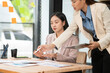© Thitisak - Asian business woman working and talking at the office