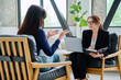 © Valerii Honcharuk - Female journalist, employer interviewing working with woman sitting together in office