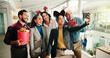 © PP/peopleimages.com - Christmas, business people and team selfie in office for photography with gift. Xmas picture, friends and happy workers with holiday spirit, December celebration or memory for social media at party