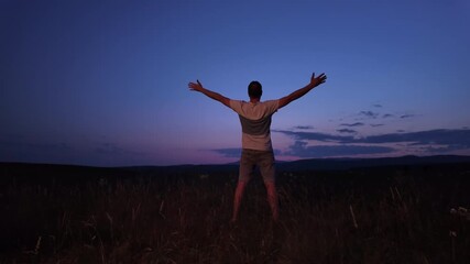 Wall Mural - man with arms wide open enjoying outdoors under stars, planets and moon.