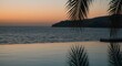 © Yani Aulia - Serene Sunset Over Ocean Reflected in Infinity Pool