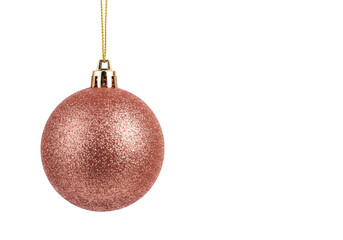 Wall Mural - A rose gold glitter christmas ornament hangs from a gold string, isolated on a transparent background