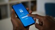 © Khoirul - Dark-skinned hand entering password on blue smartphone screen with Face ID lock