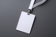 © Generative AI - Minimalist blank white identification badge with lanyard on gray background.