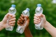 © Generative AI - Diverse hands holding empty plastic bottles in outdoor setting with green blurred background.