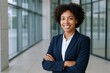 © Generative AI - Confident Female Business Professional Smiling with Arms Crossed in Modern Office Environment.