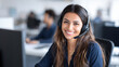 © UniqGraphicX - Young smiling Indian woman working in customer care smiling and talking with clients. Help desk and call center office