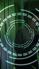 Wall Mural - digital target animation over person using tablet in dark server room