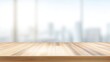 © Nanang - Wooden tabletop against a blurred cityscape through a large window