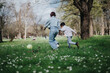 © qunica.com - A joyful moment between a woman and a child enjoying outdoor activity amidst nature. The scene captures the beauty of human interaction and leisure in a park filled with greenery and life.