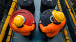 © photo for everything - Workers handling wire spools in a factory. The image showcases industrial work, safety protocols, and material handling.