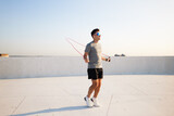Jumping rope at sunset on a rooftop with stunning views of the harbor