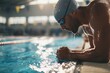 © Nutnapa - Swimmer practicing in indoor pool competitive training aquatic environment close-up perspective focus on performance