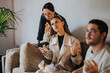 © qunica.com - A group of students share breakfast, engaging in conversation and enjoying downtime during a school break. The scene captures a casual and relaxed atmosphere among the friends.
