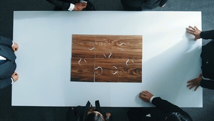 Wall Mural - top view of business people putting jigsaw together at meeting room. professional marketing team sta