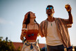 © Drazen - Carefree couple drinking beer and having fun during summer music festival.