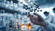 © Yus - A scientist in a lab holds a molecular model
