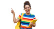 © MdMostafizur - An excited young student with glasses and a colorful shirt points upwards while holding a book and backpack isolated on transparent background