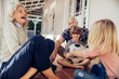 © Marko Geber - Grandparents and grandchildren playing and having fun together on a balcony of their house