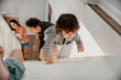 © Marko Geber - Happy young caucasian family playing together at home on a staircase