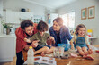 © Marko Geber - Young caucasian family being messy and having fun baking together in the kitchen