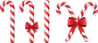 © Jala - A group of red and white striped candy canes with red bows on a white background for christmas