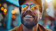 © Serega - Bearded man smiling in the city, wearing glasses and a cap, sunshine, bokeh background.
