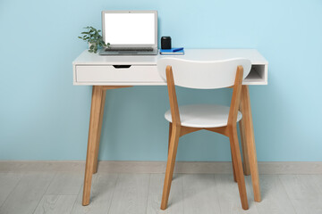 Wall Mural - comfortable workplace with laptop, table and chair