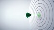© piyawat - Green dart hitting center of white target in bullseye with gradient background, arrow pointing right.