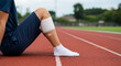 © Firyal Affina - Sports injury recovery: Athlete's bandaged leg on a running track after a workout