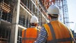 © sambath - Two construction workers in hard hats and safety vests, standing in front of a high-rise building under construction.