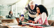 © peopleimages.com - Christmas, laptop and business people in office, help and tablet with collaboration, feedback or advice. Employees, tech or consultant in workplace, Xmas or conversation with company website or email