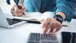 © tippapatt - Doing finance, budgeting and tax calculation. Close up woman hand using calculator to calculate home finance, accounting with laptop computer on table, budget management, monthly expenses.