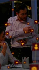 Wall Mural - animation of network of connections with icons over diverse business people at office