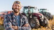 © Oleksandr - Smiling farmer with crossed arms stands in a sunny field, with tractors in the background, suggesting a successful harvest and agricultural work.
