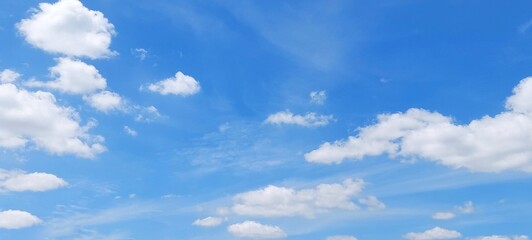 Wall Mural - Soft white clouds with a beautiful blue sky in the morning light. Soft white clouds float in the clear blue sky. Clear blue sky, bright spring, soft sky gradient.